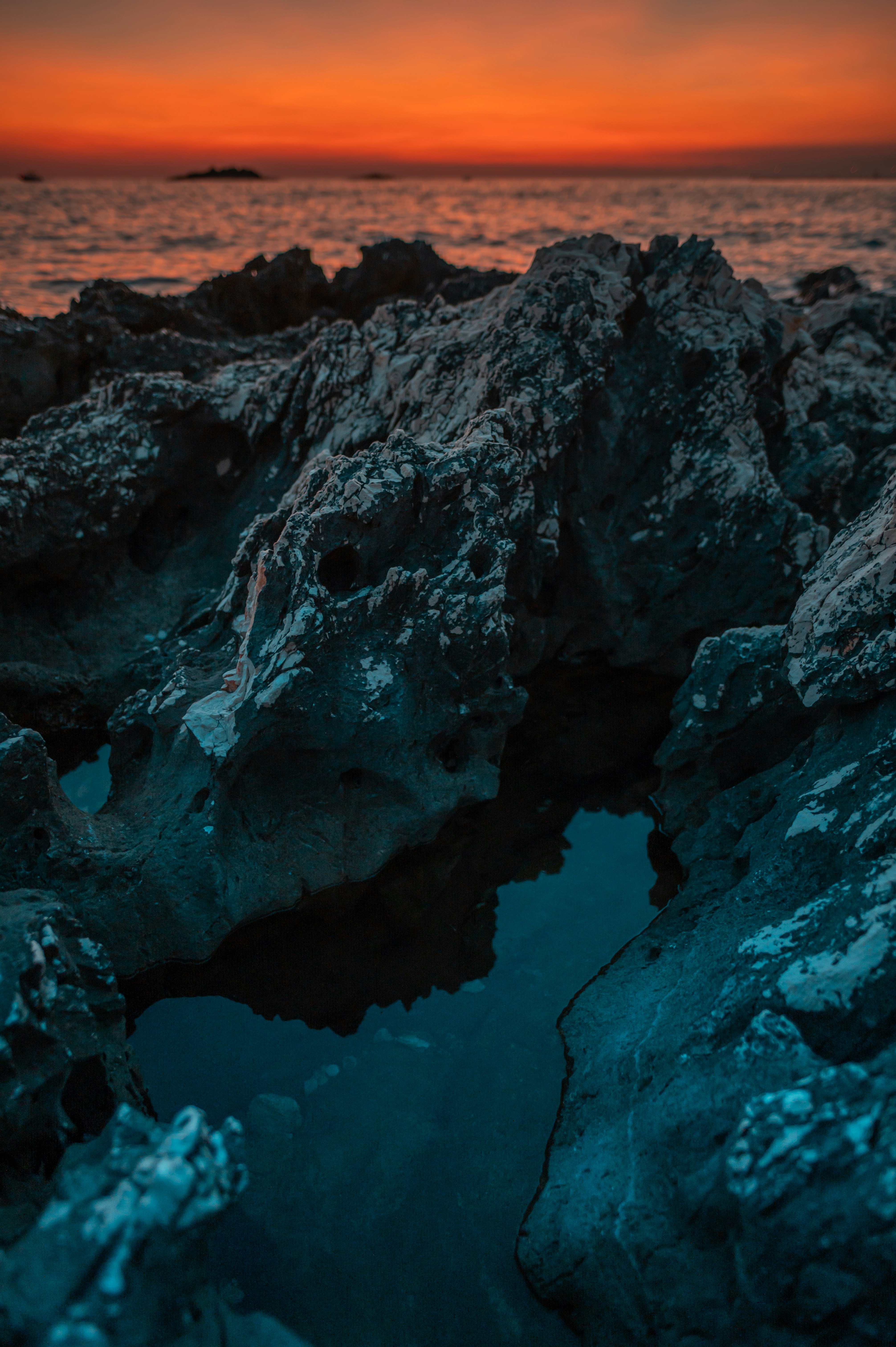 brown rock formation near body of water during daytime